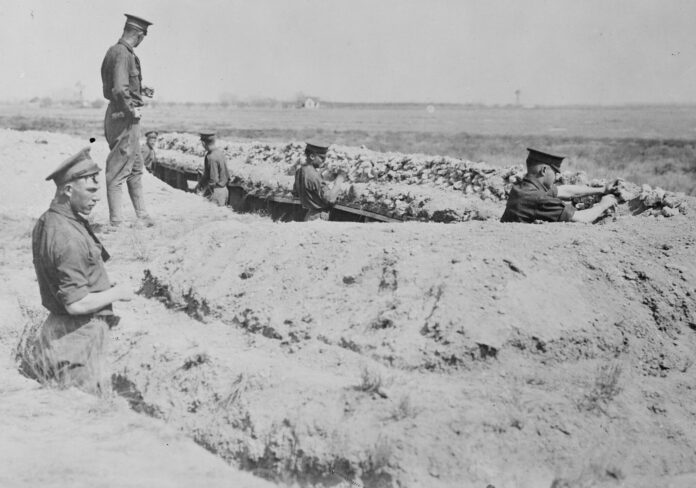 Cadets from the New Mexico Military Institute digging a trench between 1915 and 1920.