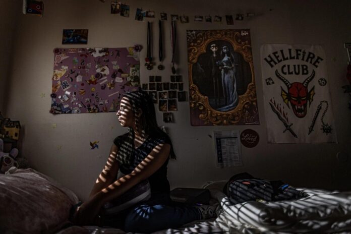 Larissa, now 14, sits in her bedroom after she finished her homeschool lessons for the day in Hobbs on Aug. 18. Last year Larissa, an honor-roll student and member of the marching band, withdrew from the Hobbs school district after reporting to her her school she had been raped.
