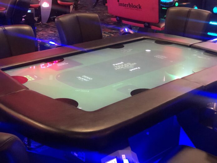 Digital poker tables sit on the main floor of the Inn of the Mountain Gods’ casino.